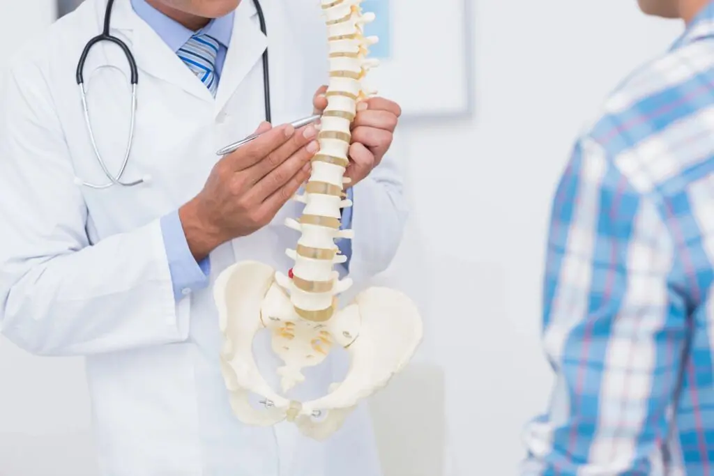 A Doctor Pointing at Backbone Parts