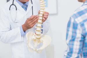 A Doctor Pointing at Backbone Parts